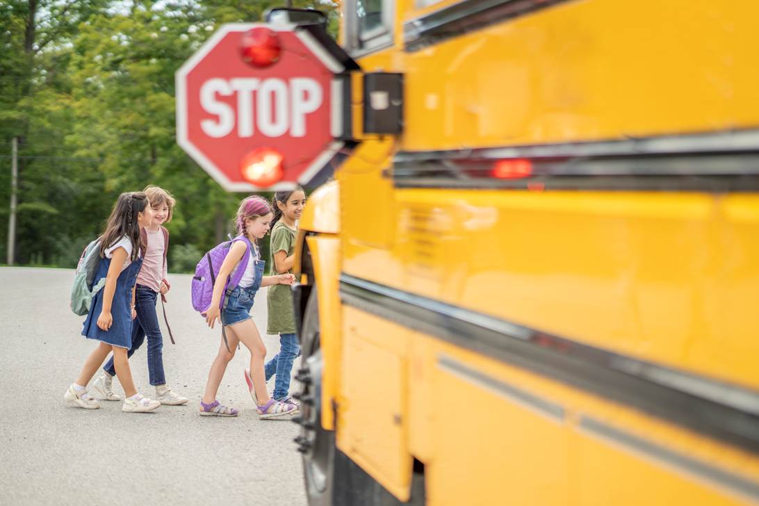 A group of children walking next to a school bus

AI-generated content may be incorrect.